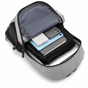 Open EasiCyco backpack holding folded clothing, a notebook, tablet, phone and power bank